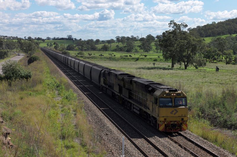 An Aurizon coal train travels through the countryside in Muswellbrook,
