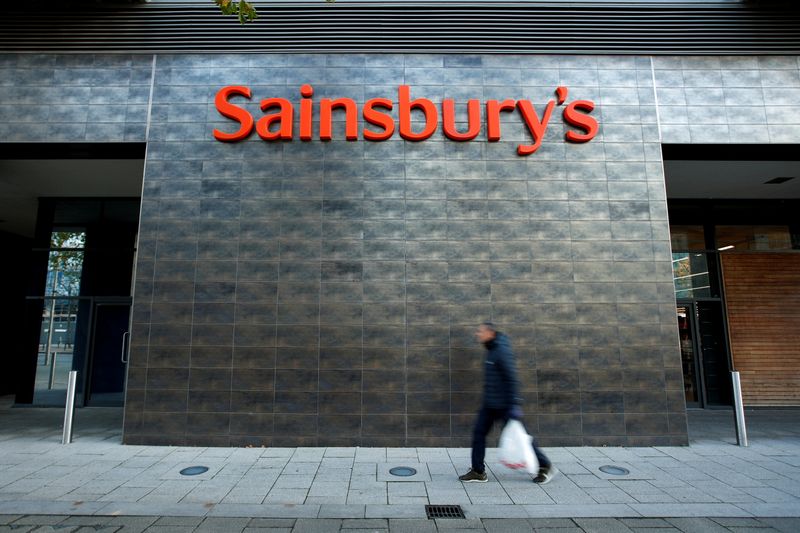 FILE PHOTO: A person walks past a Sainsbury’s store in