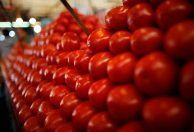 Tomatoes are displayed at a vegetable stall in La Merced