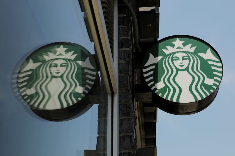 A Starbucks logo hangs outside of one of the 8,000
