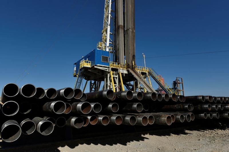 Drill pipe is seen below a drilling rig on a