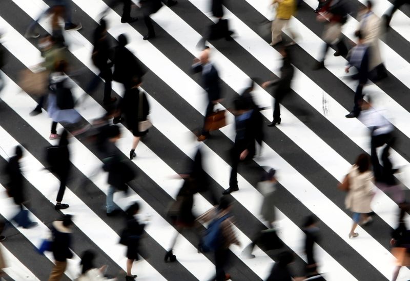 FILE PHOTO: People cross a street in Tokyo