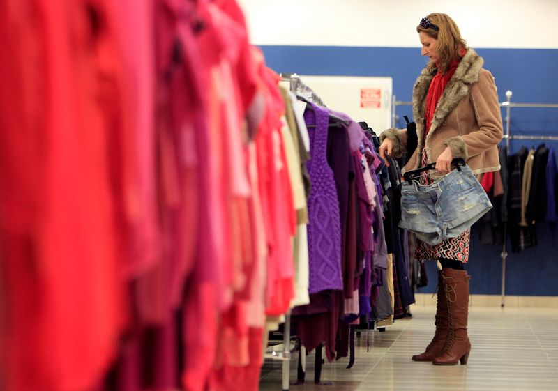 FILE PHOTO: A customer looks at clothes on display at