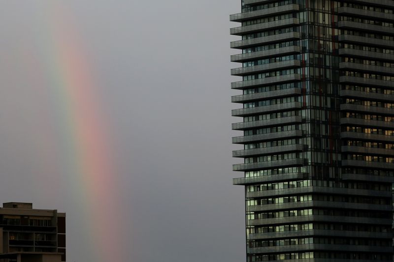 A rainbow appears past a condominium building in Toronto