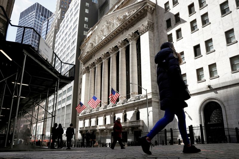 FILE PHOTO: People are seen on Wall Street outside the