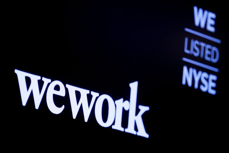 The WeWork logo is displayed on a screen during the