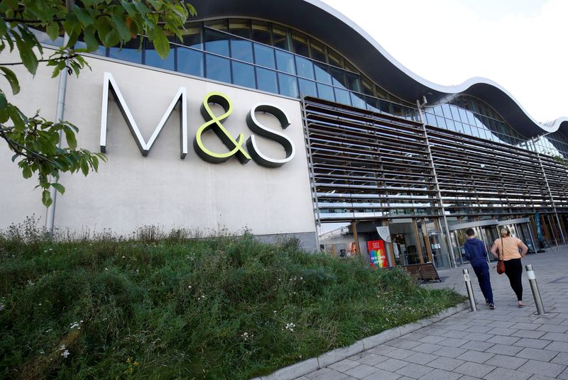 FILE PHOTO: People walk outside a Marks and Spencer (M&S)