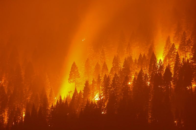 FILE PHOTO: California’s Dixie Fire burns at night in Taylorsville
