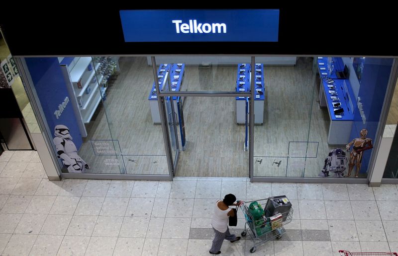 A shopper walks past a Telkom shop at a mall