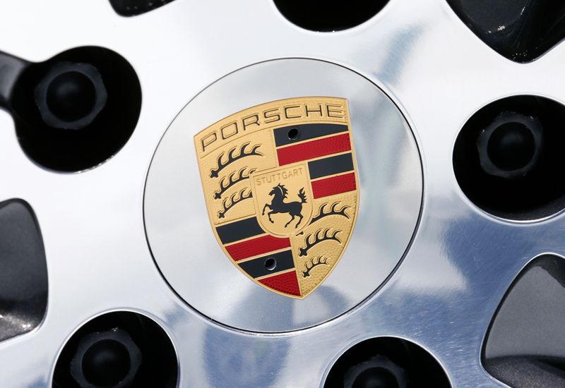 A logo is seen on a wheel of a Porsche