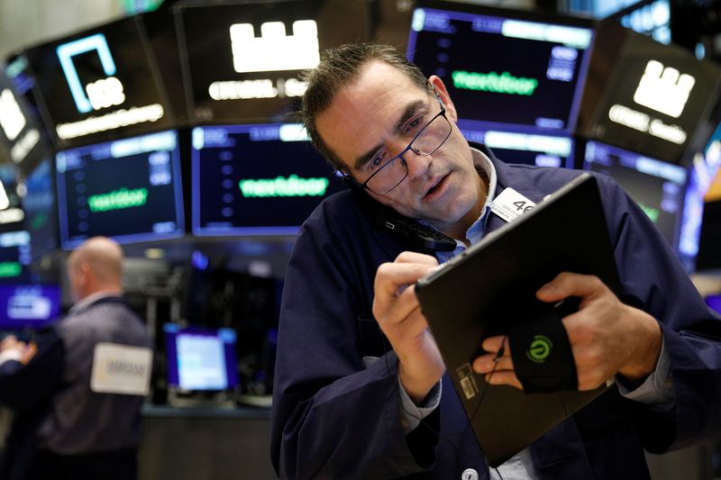 Traders work on the floor of the NYSE in New