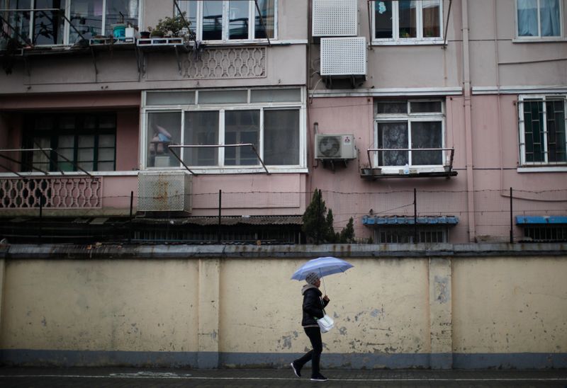 A man walks at a residential area in downtown Shanghai