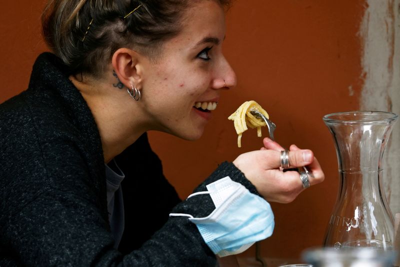 FILE PHOTO: A customer eats pasta at a restaurant in