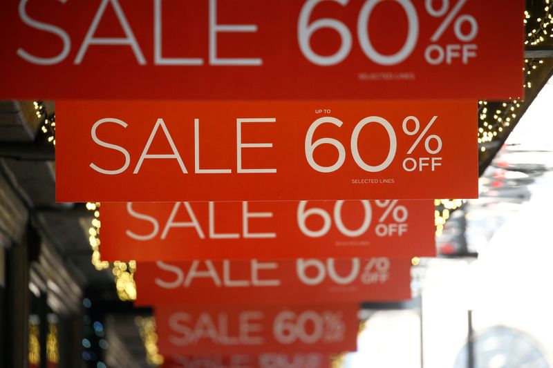 Sale signs are displayed at the front of a shop,