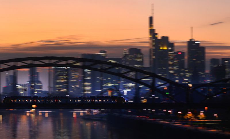 Sun sets over the skyline and ECB in Frankfurt