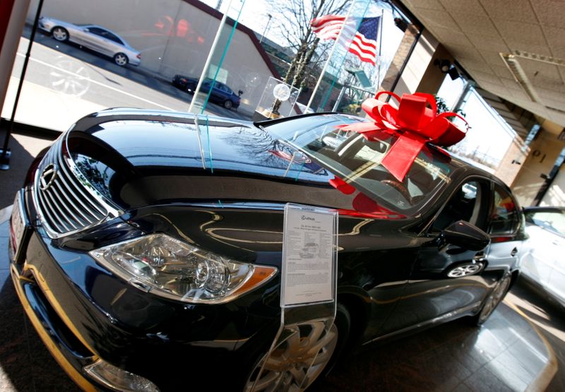 FILE PHOTO: Cars sit for sale in a Lexus dealership