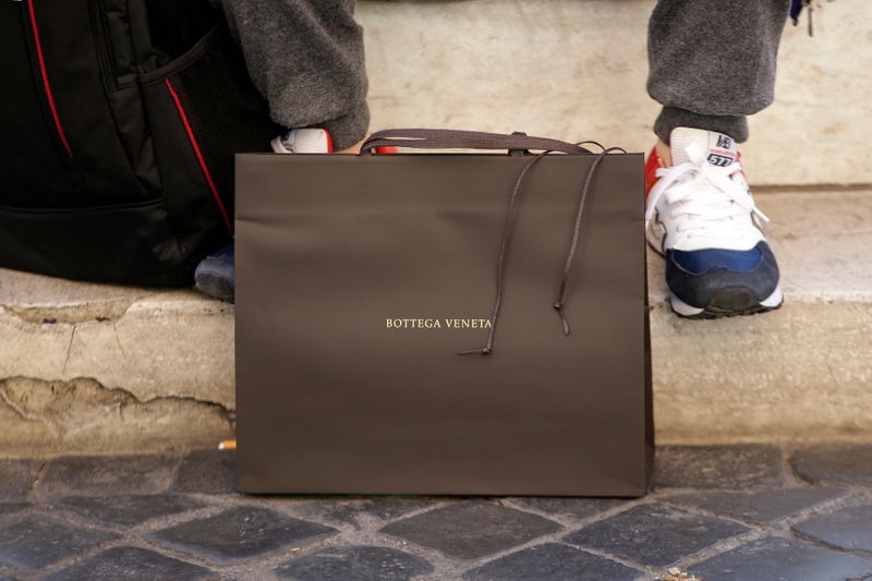 FILE PHOTO: A man sits next a Bottega Veneta bag