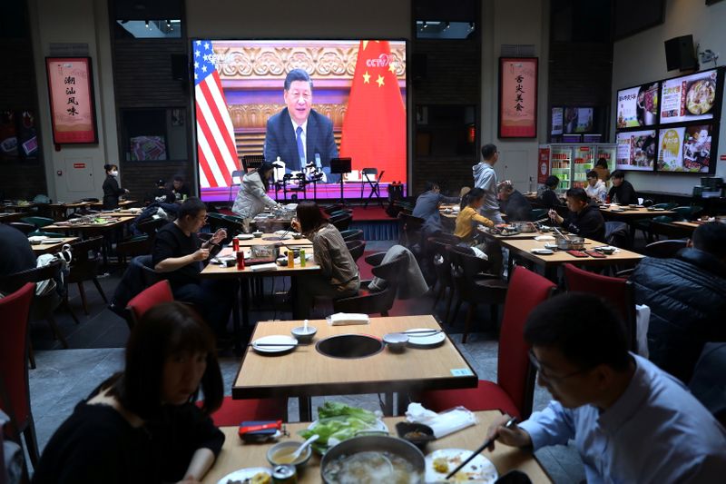 Screen shows Chinese President Xi Jinping attending a virtual meeting