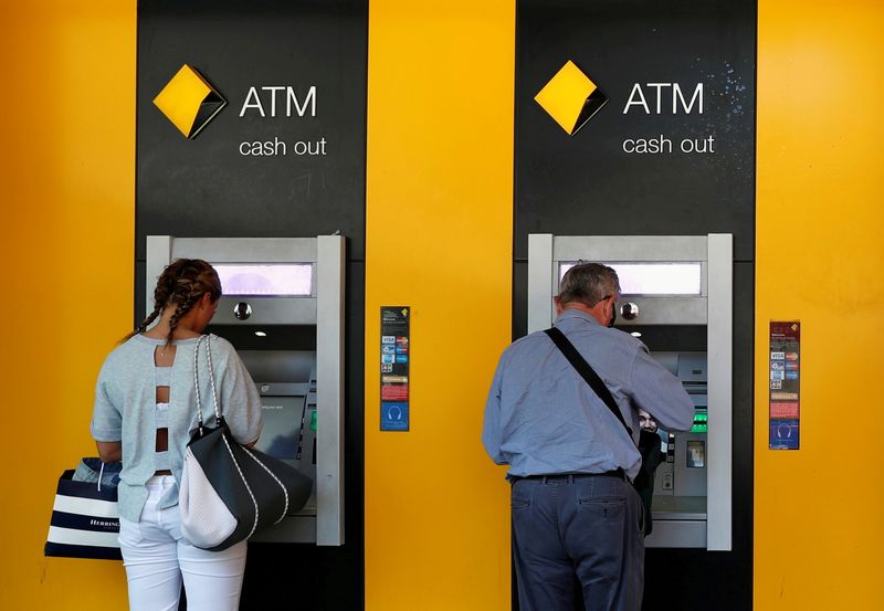 FILE PHOTO: People use Commonwealth Bank of Australia (CBA) bank