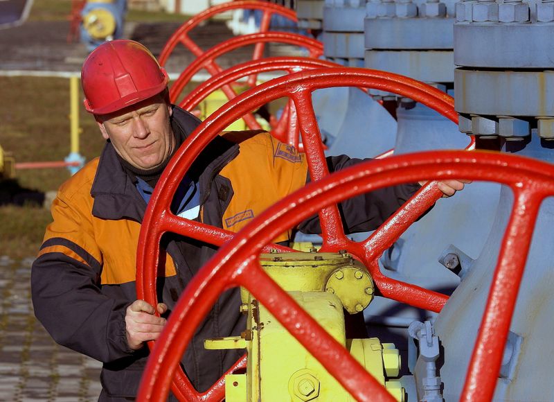 FILE PHOTO: A worker turns a valve at a gas