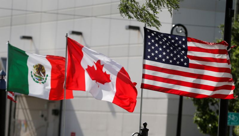 FILE PHOTO: Flags of the U.S., Canada and Mexico fly