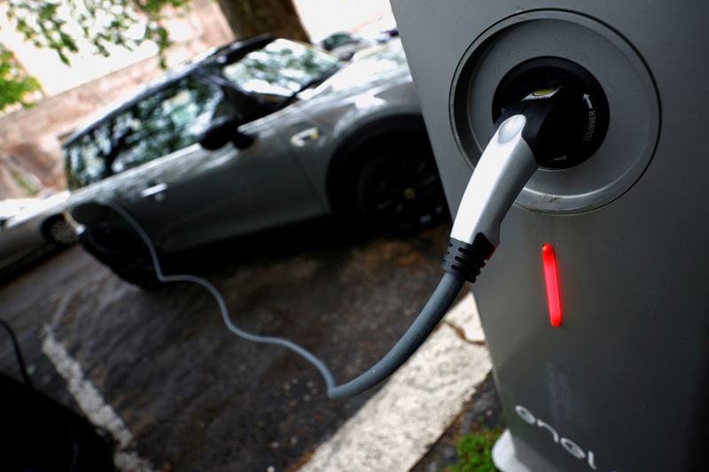 FILE PHOTO: An electric car is plugged in at a