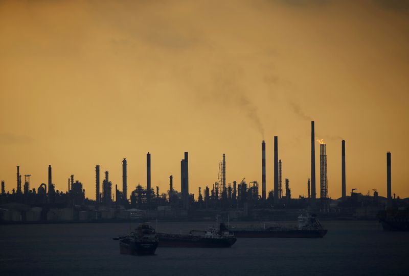 FILE PHOTO: Storm clouds gather over Shell’s Pulau Bukom oil