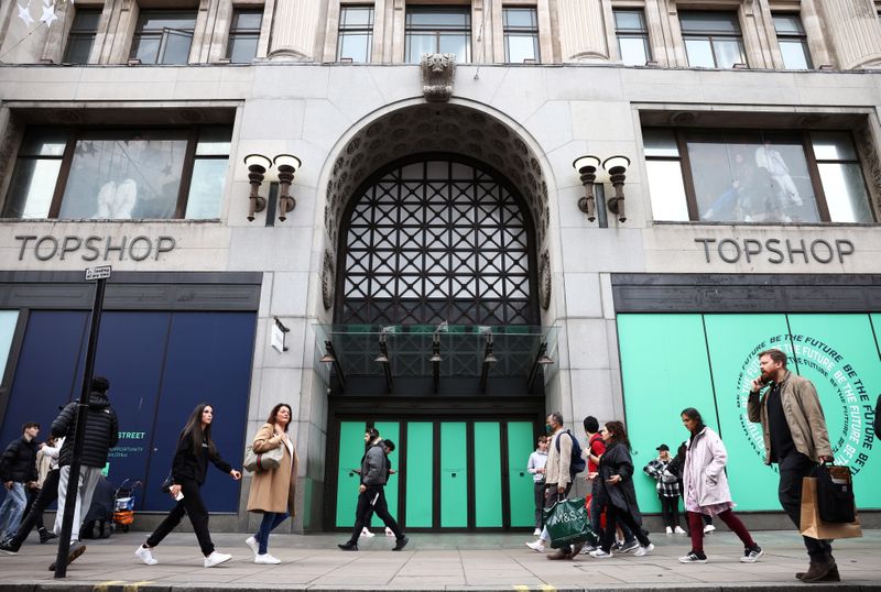 People walk past 214 Oxford Street, the former flagship store