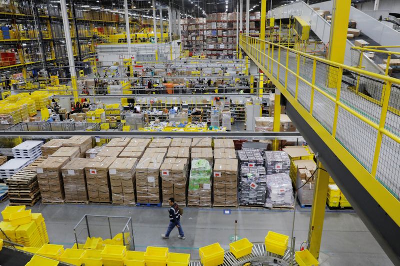 Amazon workers perform their jobs inside of an Amazon fulfillment