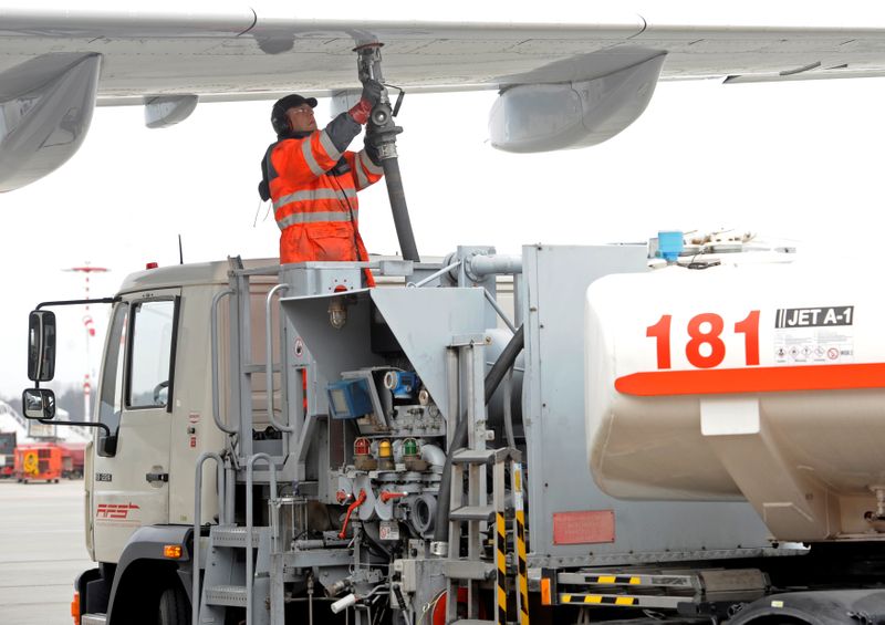 FILE PHOTO: A worker fills an Airbus jet with aviation