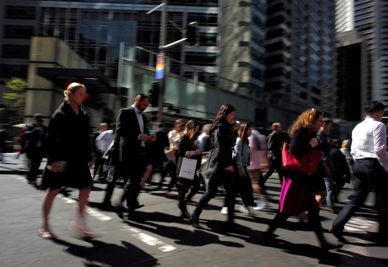 FILE PHOTO: Office workers and shoppers walk through Sydney’s central