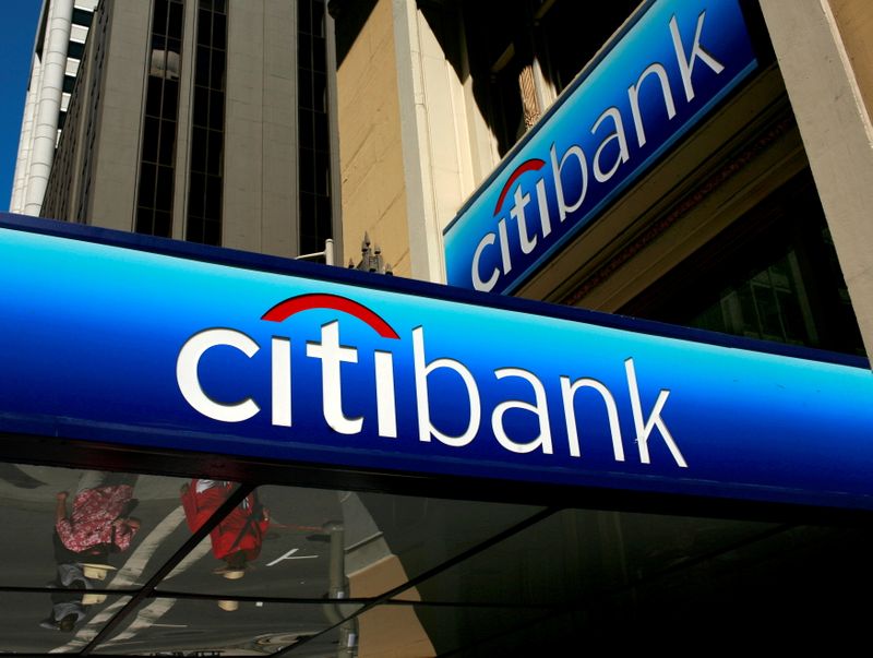FILE PHOTO: People walk beneath a Citibank branch logo in
