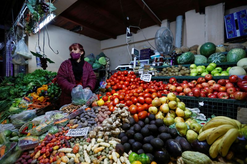 FILE PHOTO: A vegetable seller looks on as she waits