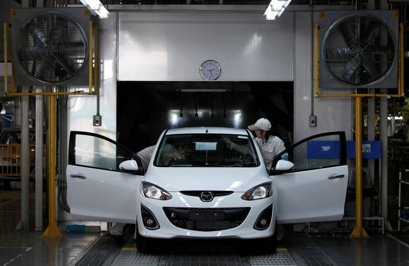 FILE PHOTO: Employees work at an assembly line in AutoAlliance