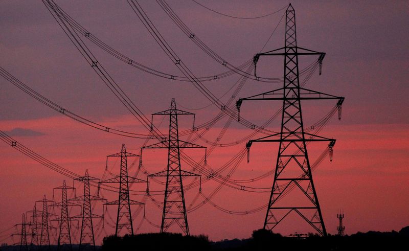 FILE PHOTO: The sun rises behind electricity pylons near Chester