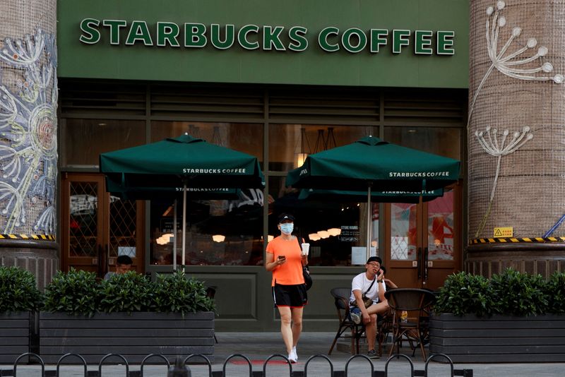 FILE PHOTO: A woman leaves a cafe of Starbucks Coffee