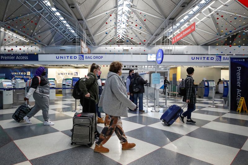 FILE PHOTO: Travelers at O’Hare International Airport ahead of the