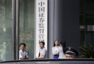 A security guard stands outside the headquarters building of China
