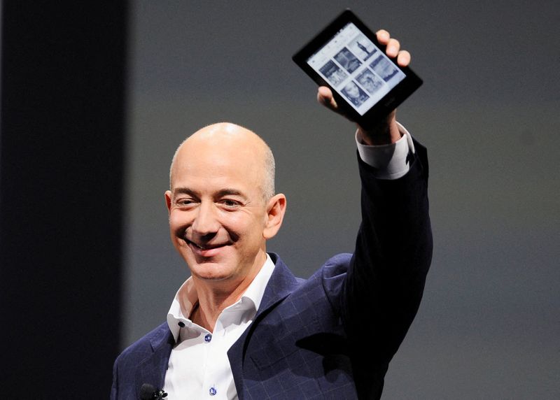 FILE PHOTO:  Amazon CEO Jeff Bezos holds up a