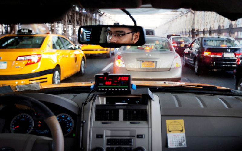 FILE PHOTO: A taxi driver navigates through heavy traffic during