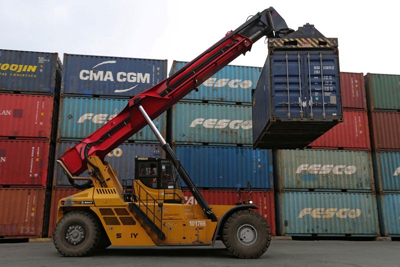 FILE PHOTO: A vehicle moves a shipping container at a