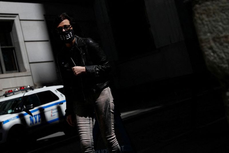 FILE PHOTO: A woman wearing a protective mask that reads