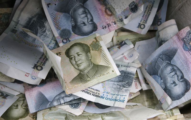 Chinese Yuan bank notes are seen at a vendor’s cashbox