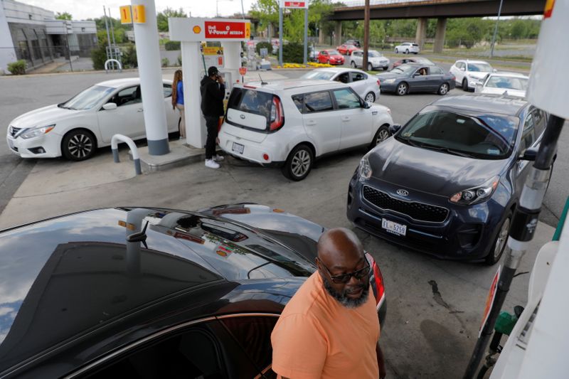 FILE PHOTO: A person fills their car with gas as