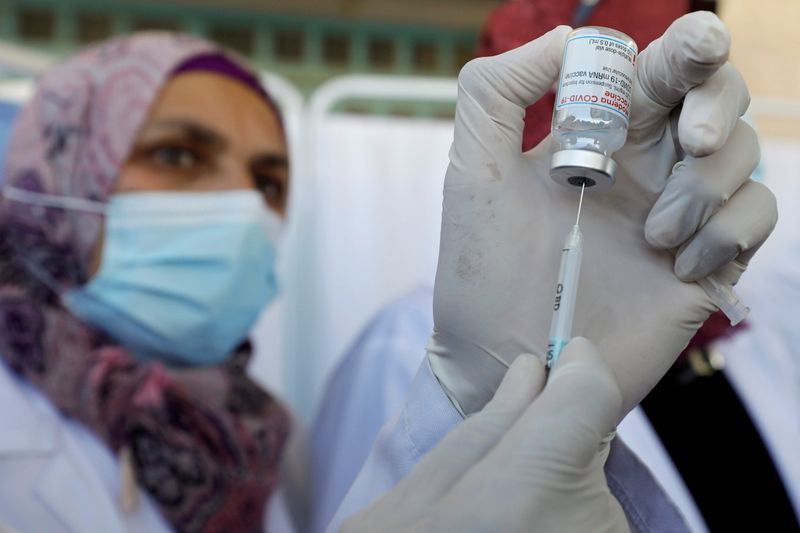 FILE PHOTO: Palestinian health workers are vaccinated against COVID-19 in