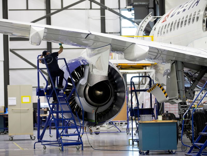 FILE PHOTO: An employee works on an Airbus A220-300 at