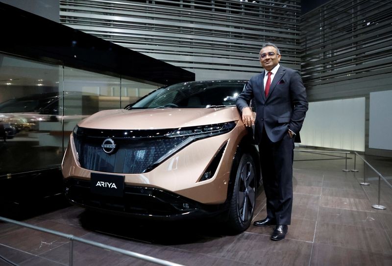 Nissan COO Ashwani Gupta poses with Ariya all-electric SUV after