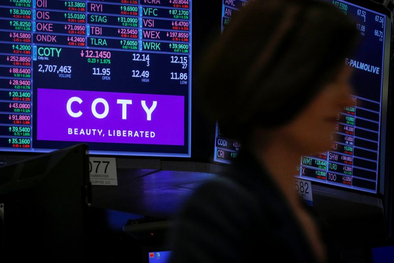 A screen displays the logo and trading information for Coty