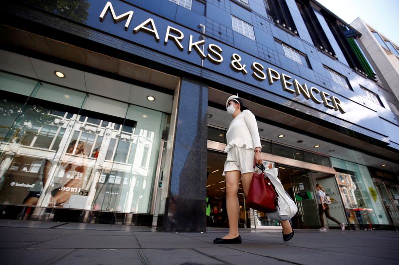 FILE PHOTO: A woman walks past a M&S store at