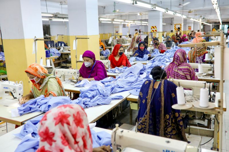 Women work in a garment factory, as factories reopened after
